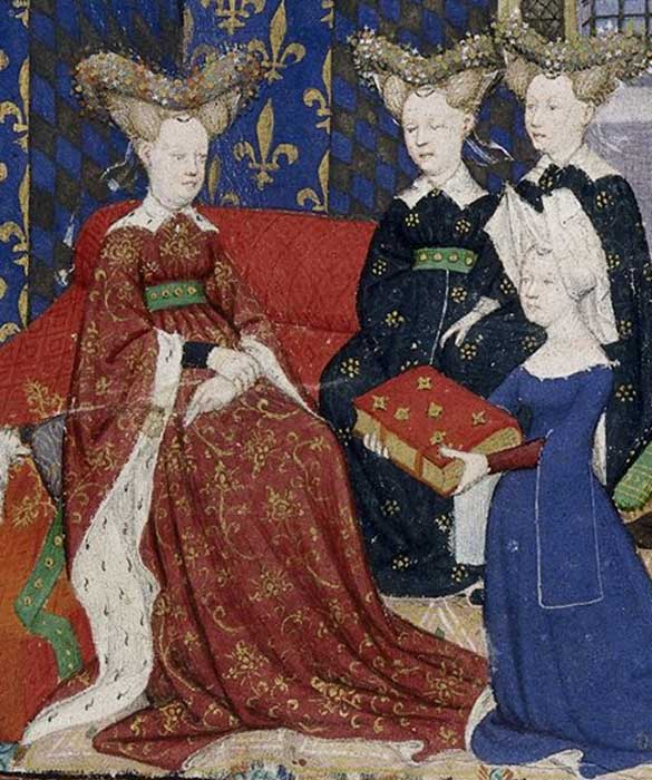 Christine de Pisan presents her book to Queen Isabeau of France. She and her ladies wear jewelled heart-shaped stuffed or hollow "bourrelets" on top of hair dressed in horns. Christine wears a divided hennin covered in white cloth.