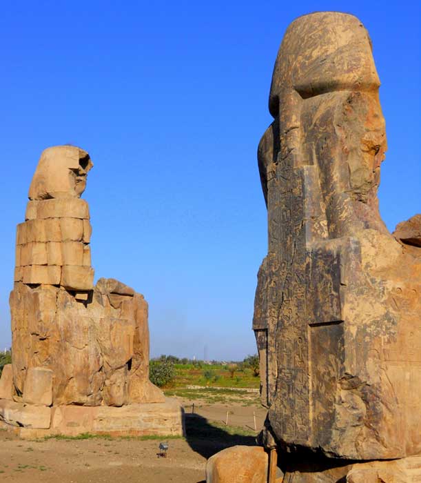 Rear view of the Colossi of Memnon: the towering 65-foot high quartzite sandstone statues that depict Amenhotep III at Kom el-Hetan, near Luxor.