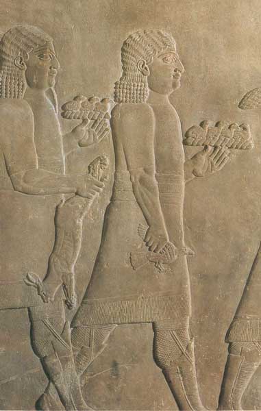 Servants back from a royal hunt bearing a hare and small birds. Relief from Ashurbanipal’s palace at Nineveh, 7th century BC. (Yale University Library)