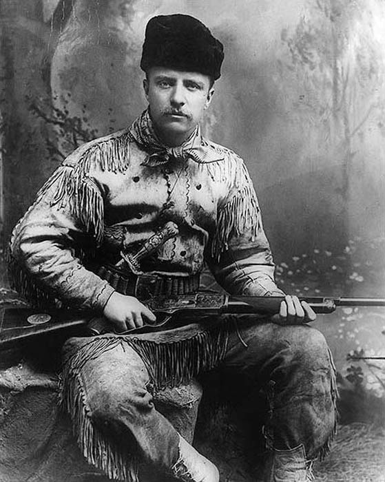 Теодор Рузвелт като ловец на безплодни земи.  Теодор Рузвелт е в ловен костюм и има издълбани ловен нож и пушка на Тифани.  Снимано от Джордж Грантъм Бейн през 1885 г. в Ню Йорк.  (Публичен домейн)
