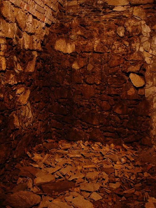 This Cess pool has human bones and other rubbish left over from when it was used as waste disposal and latrine. After prisoners were tortured to death or executed the bodies were dumped here, above was the toilet that the warden used to defecate on the dead bodies. (Emillie/CC BY 2.0)