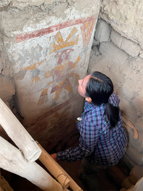 Upper and lower men are visible here on the pillar. Archaeologist Gabriela Cervantes Quequezana examines the imagery of the painted pillar. (Lisa Trever/Panamarca)