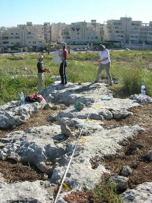 Hebrew University archaeologists analyze cup marks on rocks at Kaizer Hill quarry.