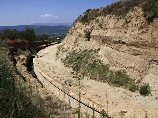 A partial view of the site where archaeologists are excavating an ancient mound in Amphipolis