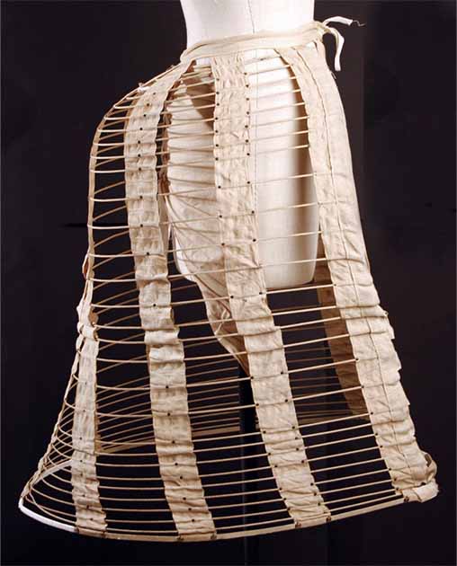 The bustles of the 19th century were bulky wire frames that shaped heavy materials and gave a slender appearance.  Bustle of the 1870s (Metropolitan Museum / Public Domain)