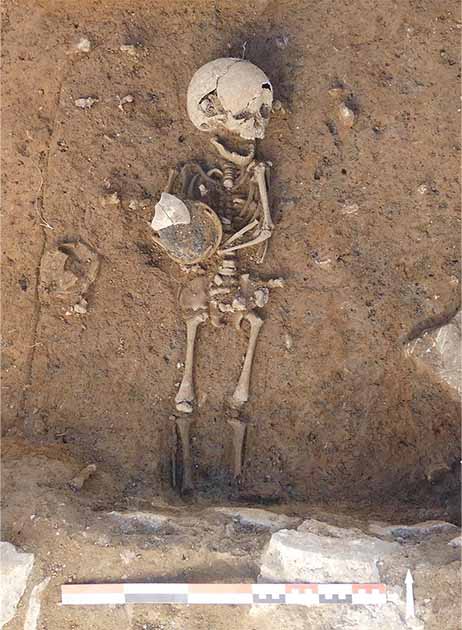 Burial of a child with a ceramic vessel (Archaeology News / J Grimaud / INRAP)
