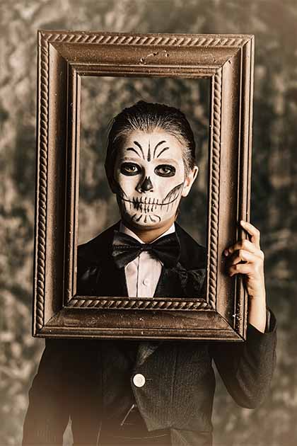 A boy dressed as Baron Samedi. (Andrey Kiselev/Adobe Stock)