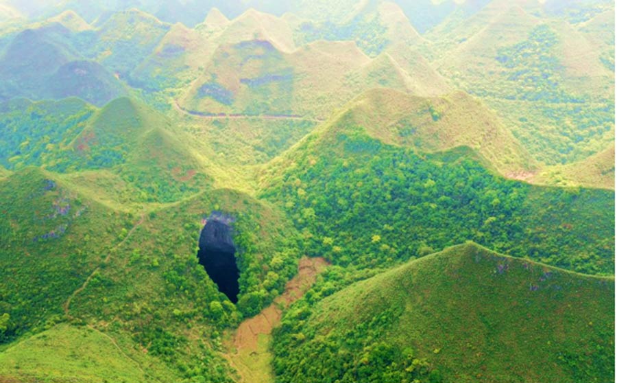 An aerial photo of the giant China sinkhole or tiankeng at Leye-Fengshan Global Geopark, in south China's Guangxi Province, which was huge and is home to an amazing primeval forest. Source: Zhou Hua / Xinhua