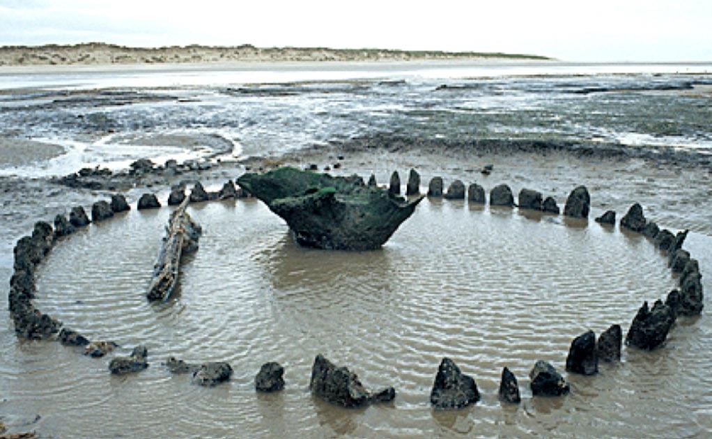 Seahenge – how it was found at low tide off the coast of Norfolk, England.     Source: Norfolk Archaeology Unit