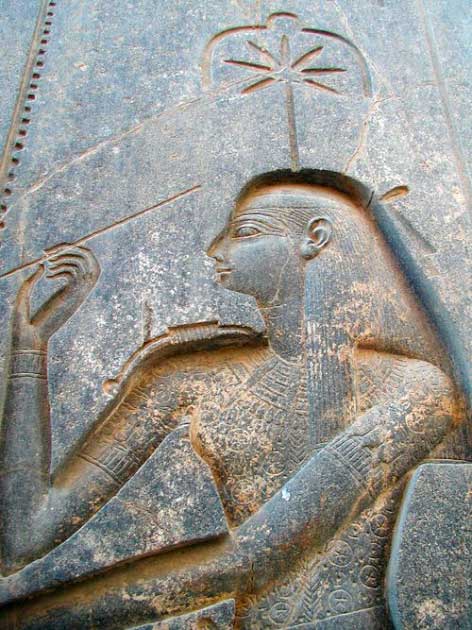 A figure of the goddess Seshat carved on the back of the throne of the seated statue of Rameses II. Above her head, there is what is argued to be a marijuana leaf. (Jon Bodsworth / Public Domain)