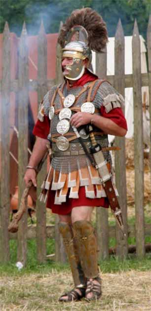 A historical reenactor in typical Roman centurion dress and armor, including leg armor and cudgel (Medium69 / CC BY SA 3.0)