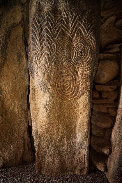 Elaborate decorations carved into a stone inside the chamber of Newgrange, one of the Irish megalith monuments. Credit: Ken Williams, shadowsandstone.com
