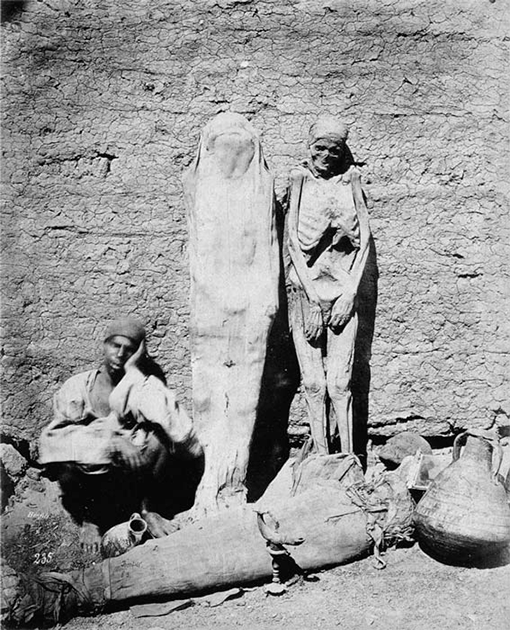 How much information has been lost by the sale of mummies to tourists and collectors in the 19th and 20th centuries? An Egyptian mummy dealer selling his wares in 1870. (Public domain)