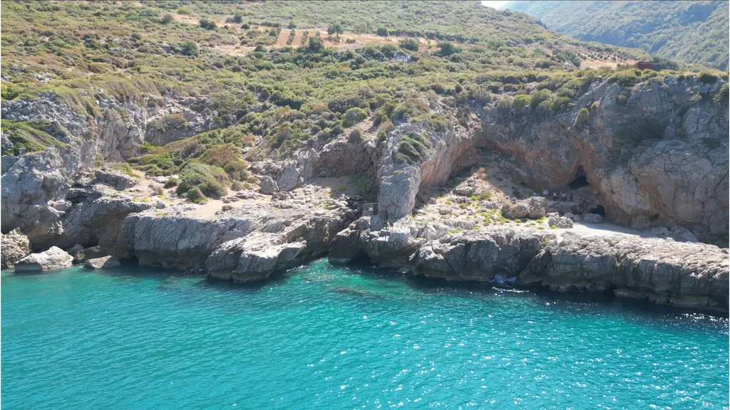 A distant view of Üçağızlı II Cave on Turkey's Mediterranean coast. Excavations at the site have revealed evidence that Neanderthals and early Homo sapiens shared remarkably similar technologies and symbolic behaviors, pointing to long-term cultural continuity in the Levant between about 77,000 and 47,000 years ago