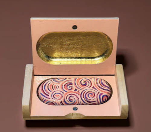 Decorated USB stick in elegant wooden case.