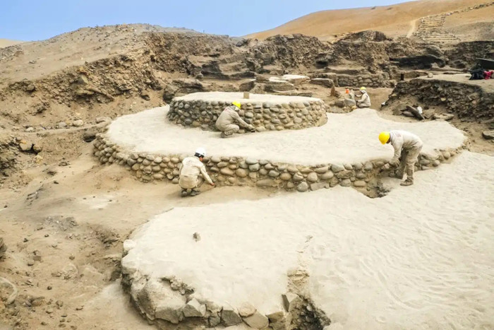 Archaeologists work on the circular stepped platform