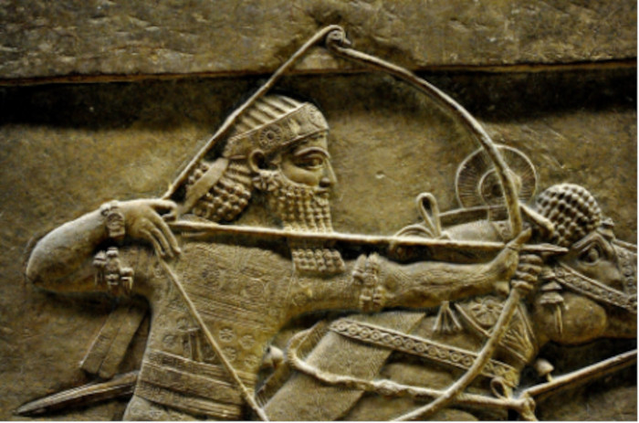 Neo-Assyrian stone relief depicting Ashurbanipal as a mounted archer in full military dress