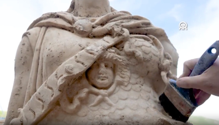 Athena statue aegis adorned with the head of Medusa close up.