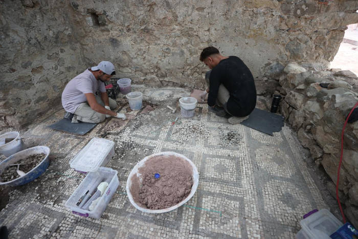 Archaeologists working on mosaic conservation inside a Byzantine-era church at Olympos 