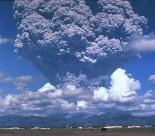 Volcano erupting spewing ash.