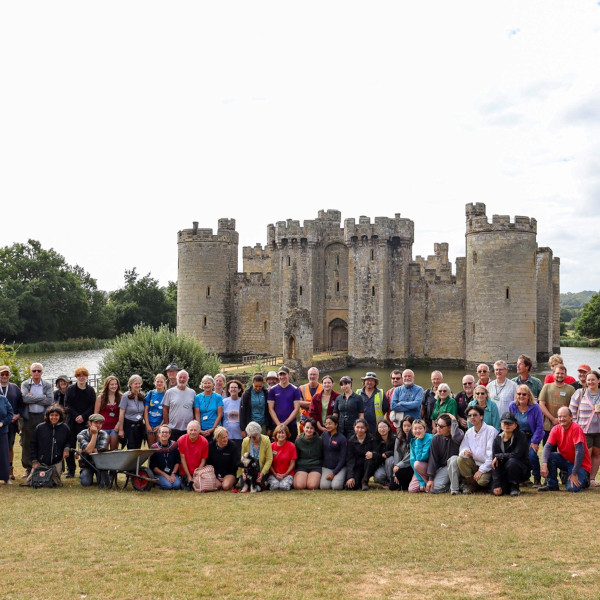 Volunteers and staff set in front of Bodiam Castle.