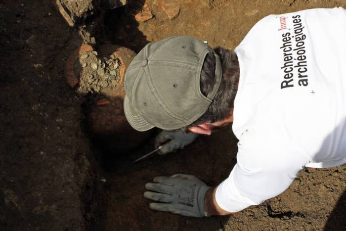 One of the coin vessels being excavated.