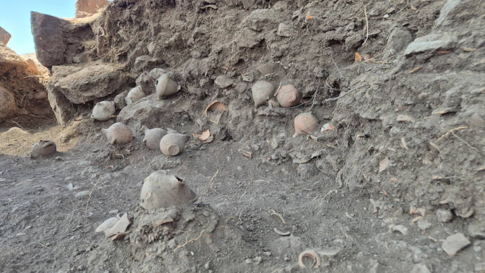 Close-up view of the nearly 1,000 miniature hydriae discovered within the temple complex. 