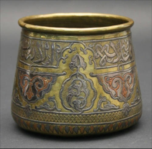 Decorated metal vessel.