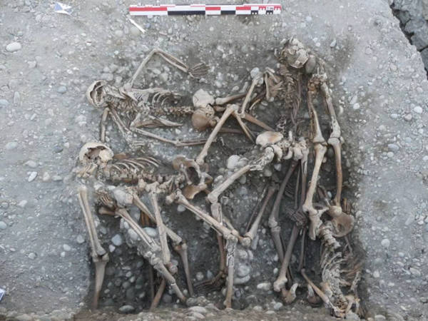 Multiple individuals buried without care in one of the discovered pits.