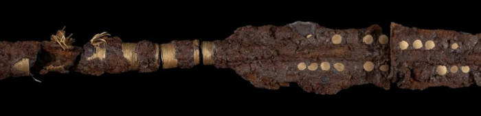 Close up of gold inlaid spear.
