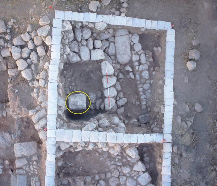 Aerial view of Room 101B after the removal of a later stone layer. The large cultic standing stone (massebah) is highlighted by the circle.
