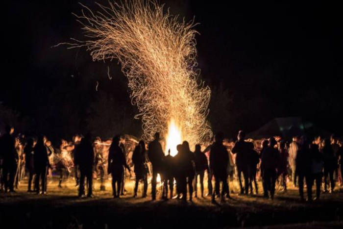 People around a bonfire at Samhain.