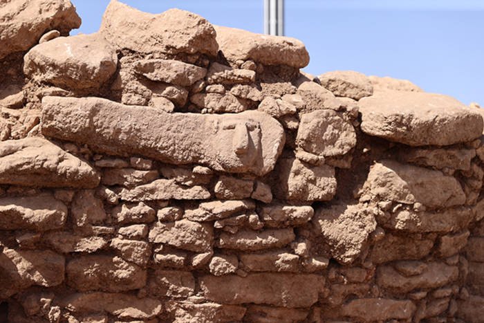 Head carving in the wall.