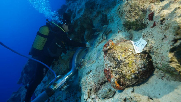 Underwater archaeologists examine and recover ancient amphorae from the shipwreck near Kekova Island in Antalya.