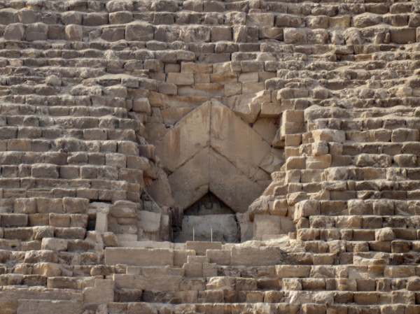 Close-up of the massive limestone casing blocks at the entrance of the Great Pyramid