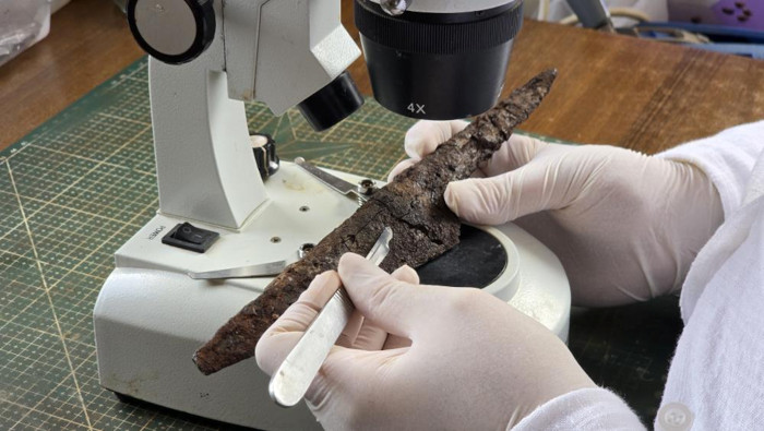 A researchers conducting analysis of one of the knives.