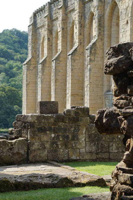 View from the cloister over the warming house ruins to the refectory, Rievaulx Abbey. 