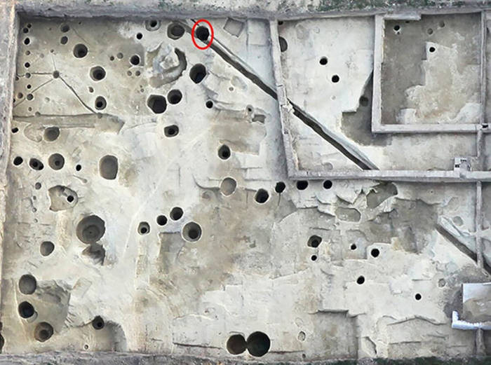 The excavation site showing the well where multiple skele.tons were found