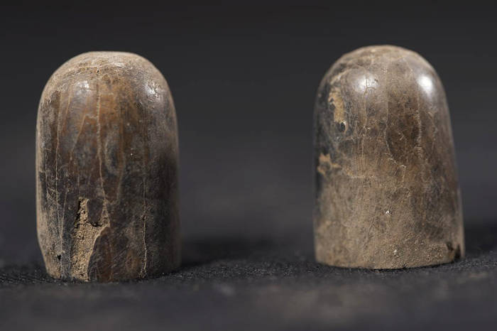 Two wooden pieces from the ancient Egyptian game Senet. 