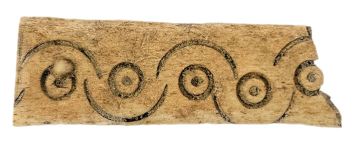 Fragment of an antler box decorated with ring-and-dot marks, from around the year 1000 AD.