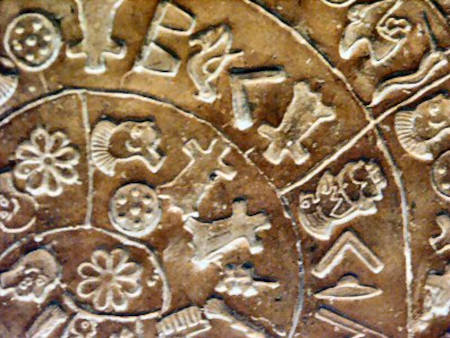 Phaistos disc symbols close up.