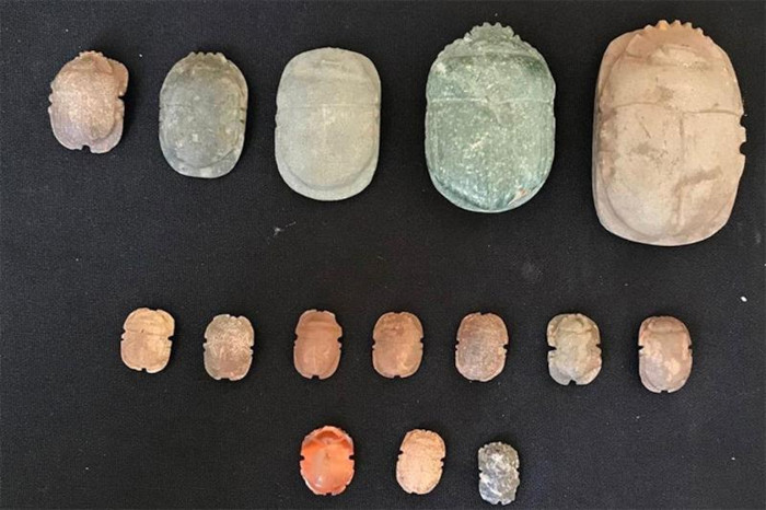A collection of scarab amulets carved from semi-precious stones.