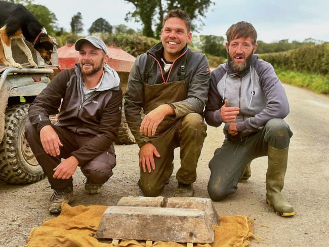 Finders and landowner outside with the ingots