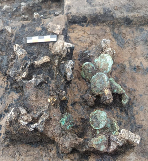 Monetary deposits and gold sheets mixed with cremated bones