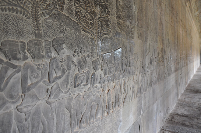 Stone bas-reliefs at Angkor Wat depicting ceremonial and religious scenes