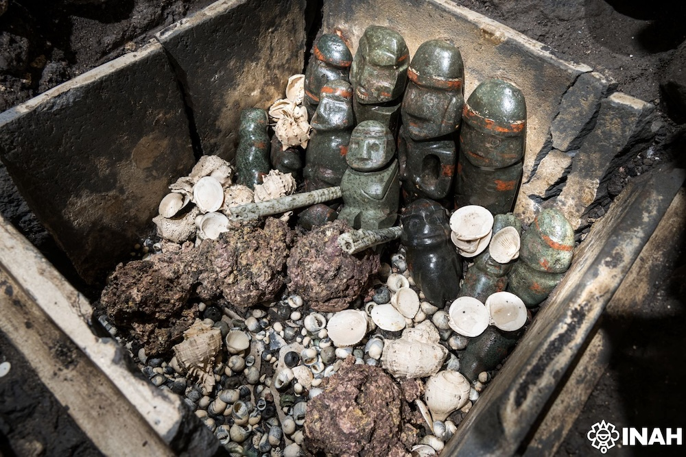 Stone offering box (tepetlacalli) containing Mezcala-style greenstone figurines, marine shells, coral, and ritual objects recovered from Offerings 186, 187, and 189 during excavations at the Templo Mayor in Mexico City