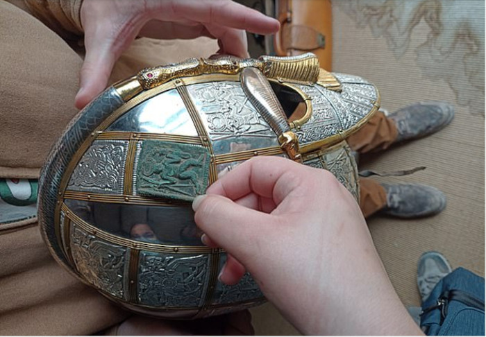 Photo indicating how the die might have been used to make the panels on the top and front of a helmet. 