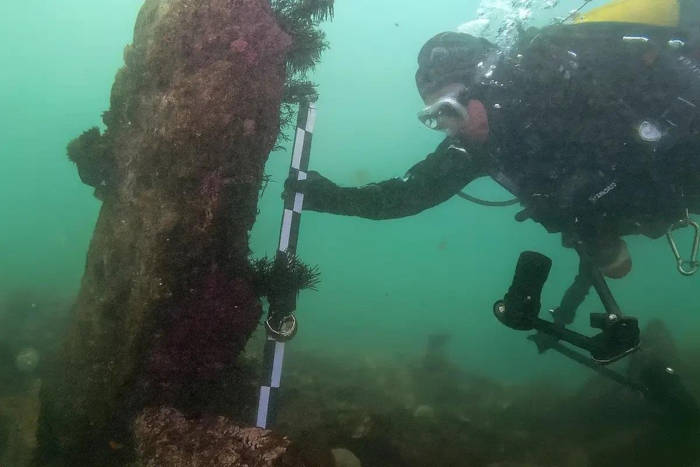 Divers exploring the submerged stone structures.