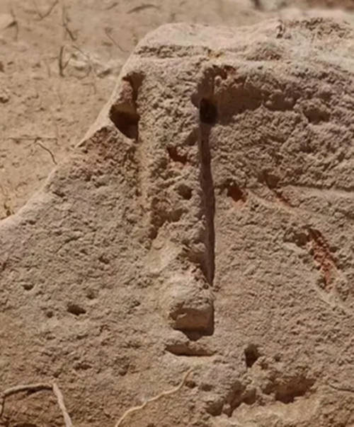 The stylized face has a long, prominent nose 