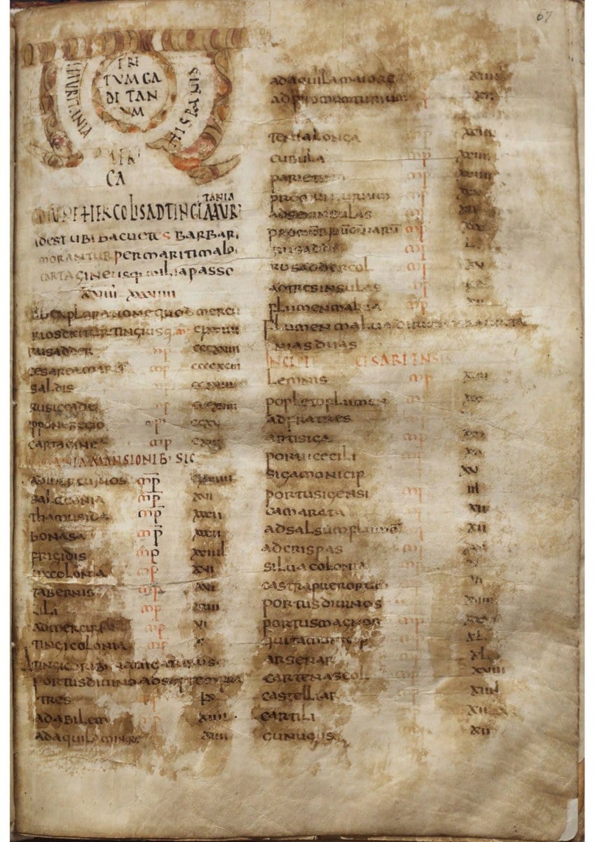 A worn manuscript page with a decorated heading at top left and two columns of place names and numbers in brown and red ink